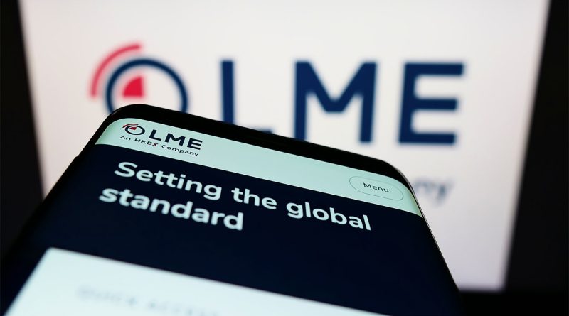 Image of a mobile phone screen pointing towards the London Metal Exchange company logo on a screen