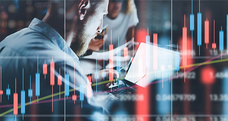 Man looking at laptop screen with graph overlayed