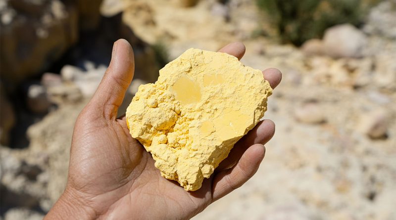 Person holding uranium ore at mining site