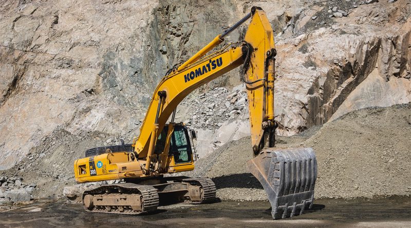 Autonomous Komatsu haul truck operating in a smart open-pit mine with AI sensors and rugged terrain